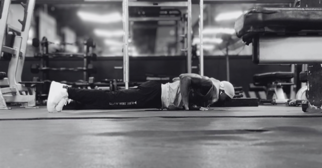 Strength Training Recovery Tips After 30: Anthony performing a push-up to build upper-body strength and endurance.