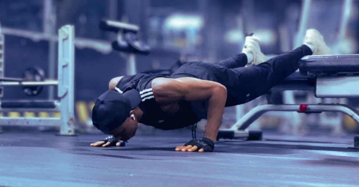 Anthony performing a decline push-up during beginner at-home strength training after 30, an advanced bodyweight exercise that helps build upper-body and core strength.