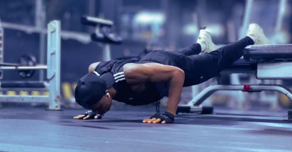Anthony performing a decline push-up in the gym during Strength Training for Weight Loss After 30, targeting the upper chest, shoulders, and triceps.