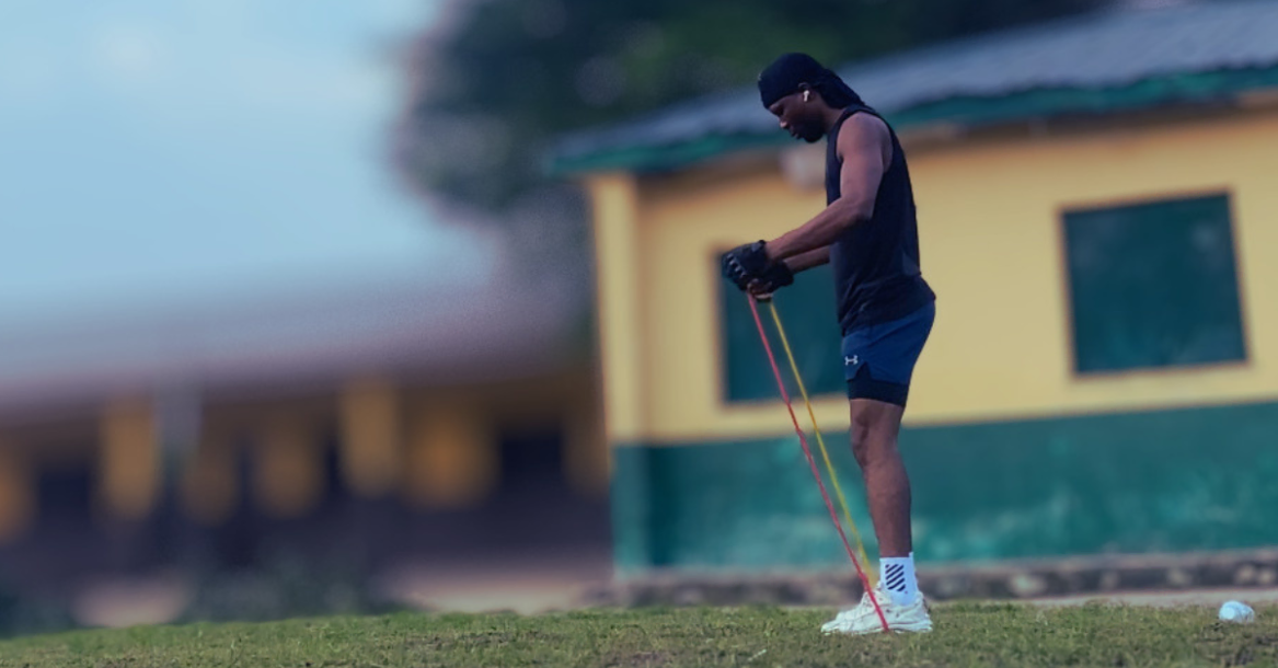 Anthony about to perform a resistance band workout as part of How to Stay Consistent with Home Workouts After 30, focusing on building strength and maintaining fitness at home.