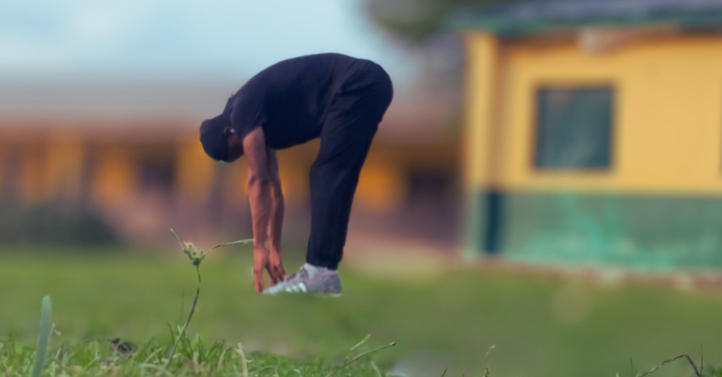 Anthony touching his toes during a flexibility exercise, showing that Are Home Workouts Effective After 30 includes mobility, stretching, and recovery for overall fitness.