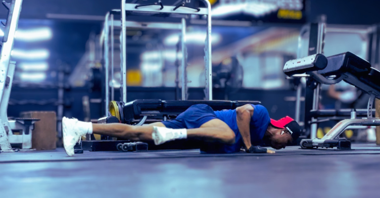 Anthony performing a Spiderman push-up as part of a strength training routine, demonstrating How Often Should You Strength Train After 30? for improved fitness and muscle development.