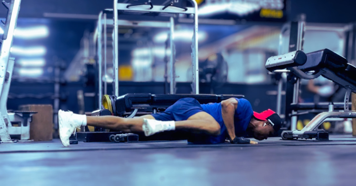 Anthony performing a Spiderman push-up as part of a strength training routine, demonstrating How Often Should You Strength Train After 30? for improved fitness and muscle development.
