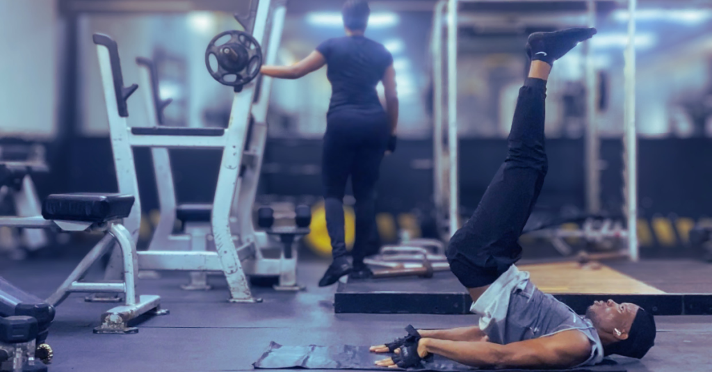 Anthony performing leg raises on a workout mat, strengthening his core with one of the best exercises for weight loss after 30 for abdominal endurance.