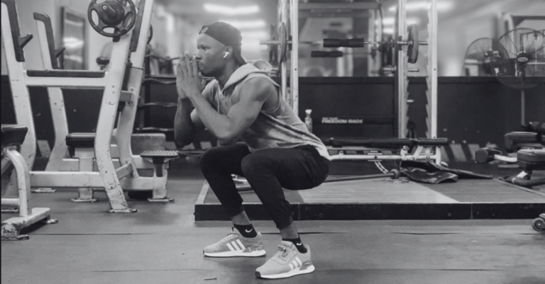 Anthony performing bodyweight squats as part of How to Build Muscle at Home After 30, a foundational exercise for strengthening the legs, glutes, and core.