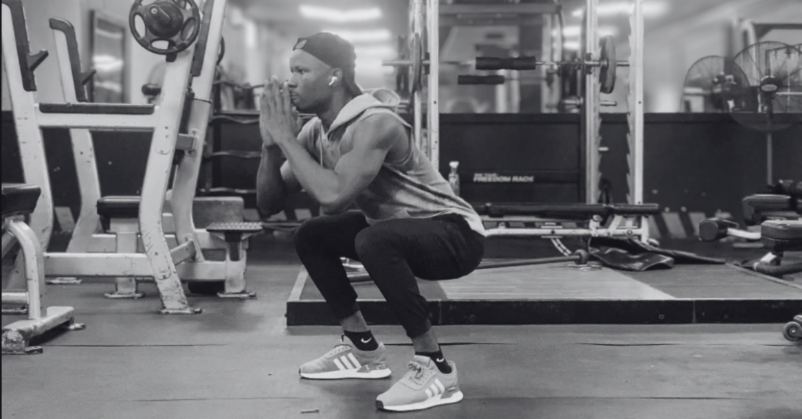 Anthony performing bodyweight squats as part of How to Build Muscle at Home After 30, a foundational exercise for strengthening the legs, glutes, and core.