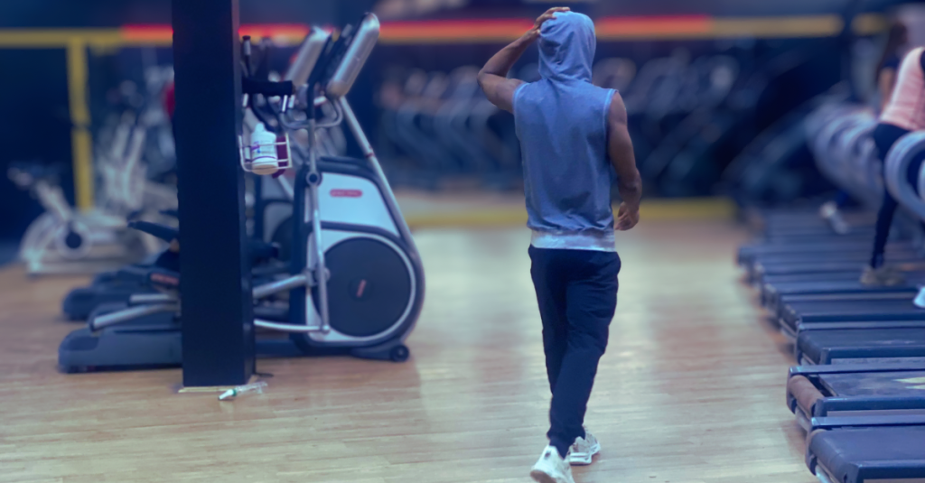 Back view of Anthony walking through the gym after training, showing Why Recovery Matters More After 30 and the importance of active recovery after exercise.