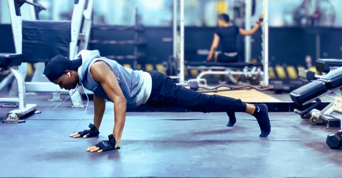 Anthony performing push-ups during a bodyweight workout session, demonstrating one of the best exercises for weight loss after 30 and full-body strength.
