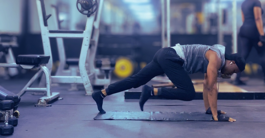 Anthony performing mountain climbers during a high-intensity bodyweight workout, one of the best exercises for weight loss and cardiovascular fitness.