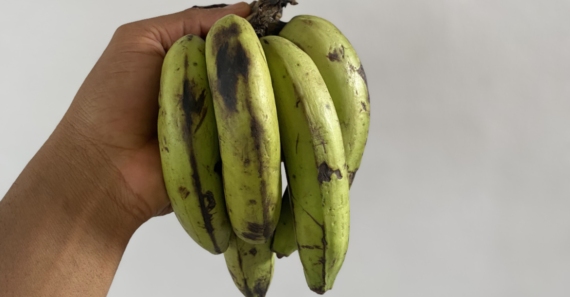 Anthony holding a bunch of bananas, one of the Best Foods for Recovery After 30, providing carbohydrates and nutrients that support energy replenishment and muscle recovery