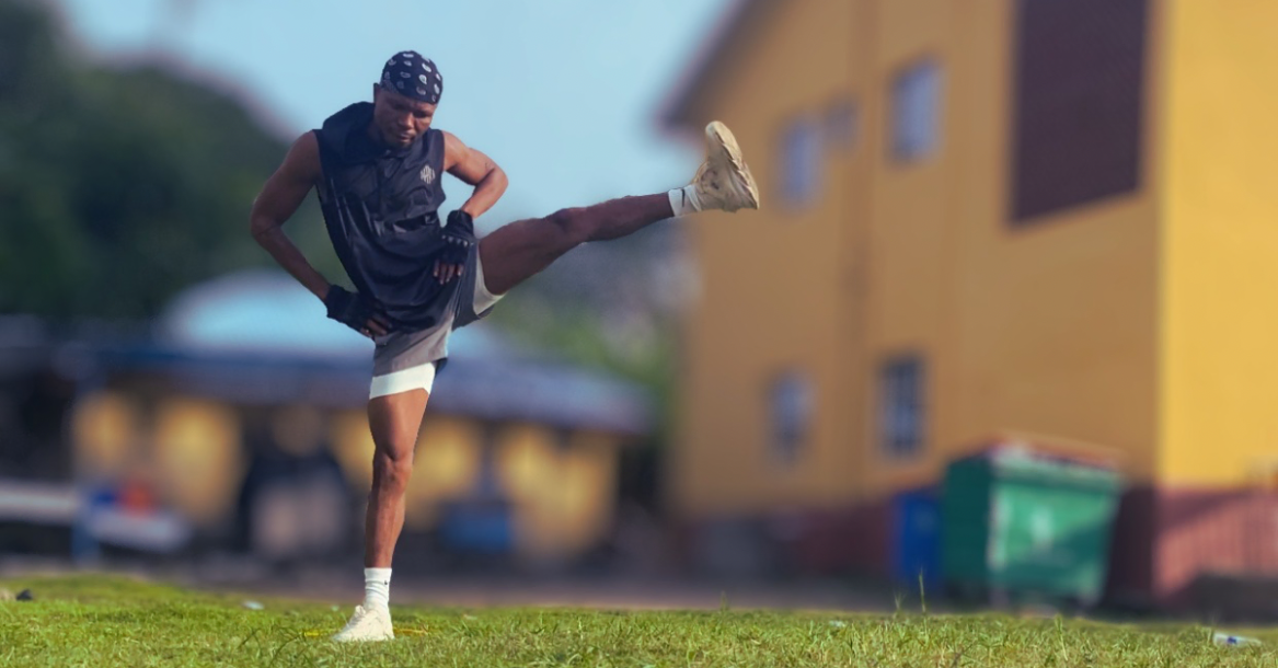 Anthony performing a side leg raise while balancing on one leg during how to plan weekly home workouts after 30, demonstrating balance, stability, and lower-body strength.