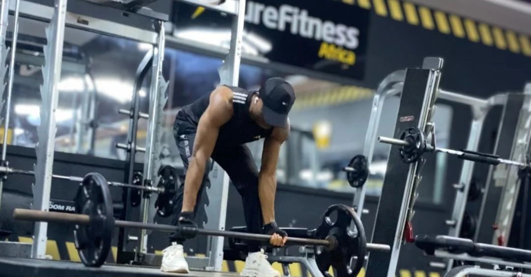Strength Training: Anthony performing a barbell deadlift to build full-body strength and power.