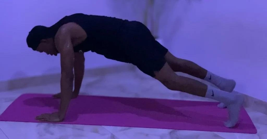 Home Workout Mistakes: Anthony performing a push-up at home as part of a bodyweight fitness routine.