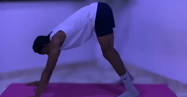 Home Workout Mistakes: Anthony preparing for a home workout session by warming up before exercise.