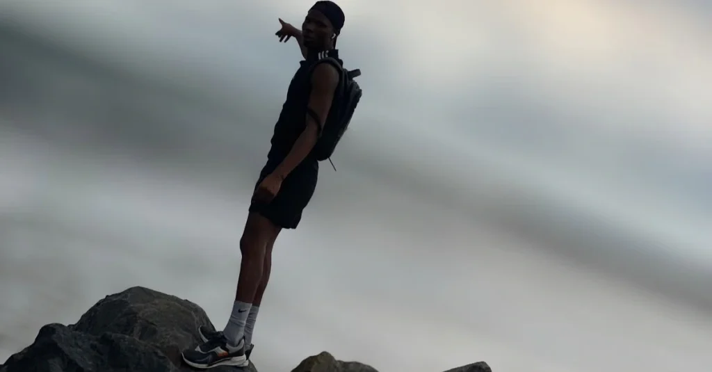 Anthony standing on a rock and observing the surrounding nature