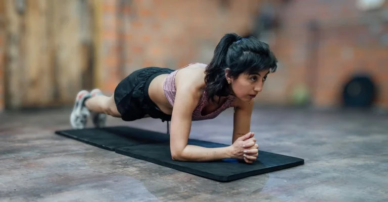 Woman doing a plank during beginner at-home strength training
