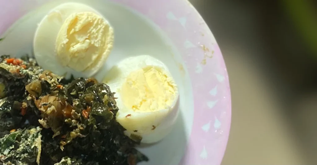 Anthony holding a bowl of sliced eggs and vegetables for a low carb breakfast