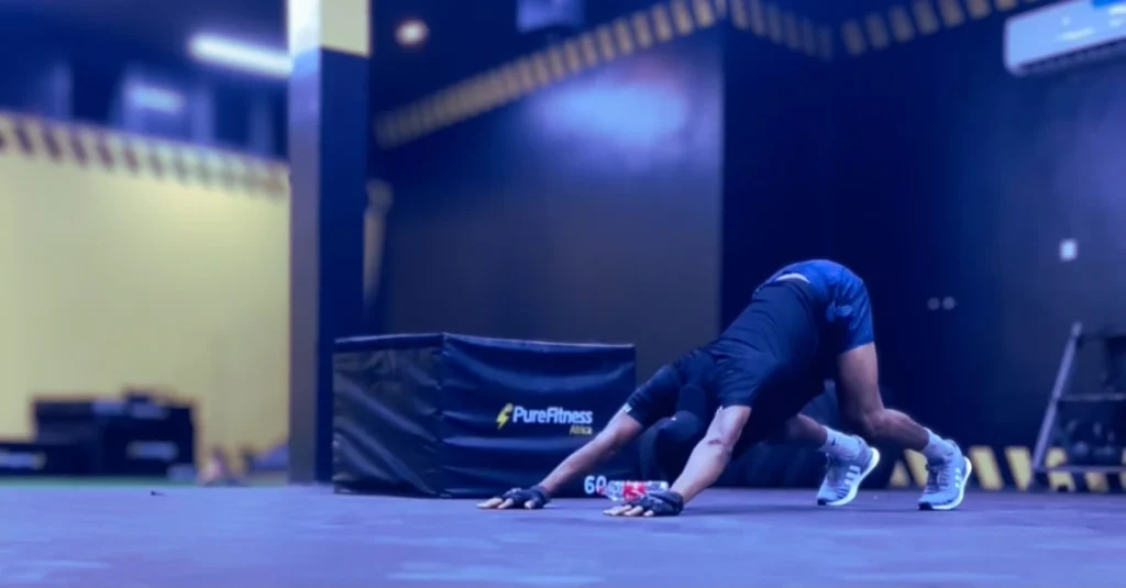 Anthony is preparing to do a push-up while demonstrating healthy habits that address why belly fat increases after 30