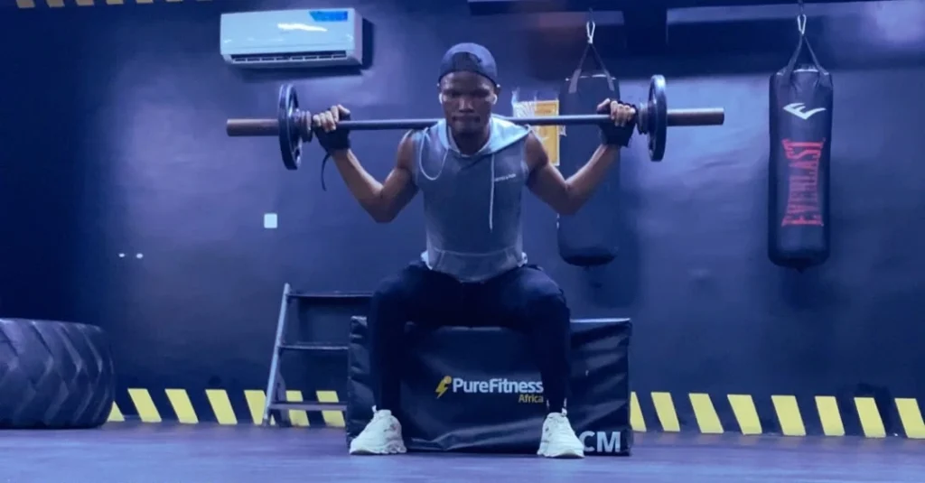Anthony performing a box squat during a cardio before or after weights workout for fat loss after 30