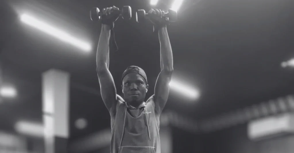 Anthony is performing the Arnold press Exercise after 30 with dumbbells to strengthen the shoulders and build upper-body muscle.