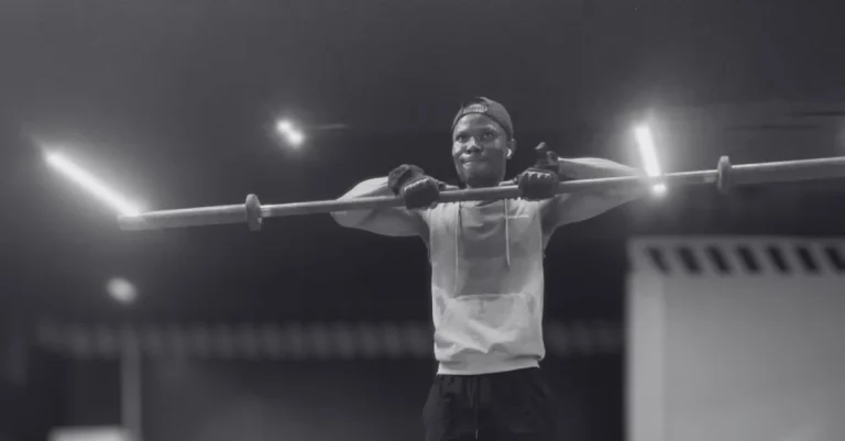 Anthony is performing the Upright Row Exercise with a barbell using proper form