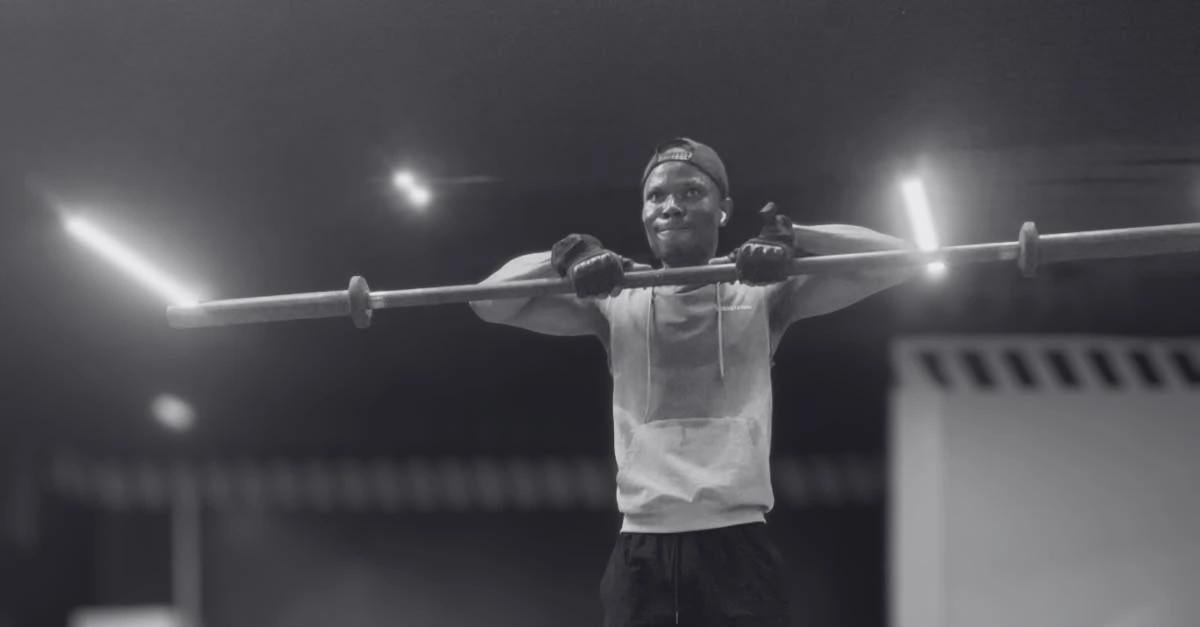 Anthony is performing the Upright Row Exercise with a barbell using proper form