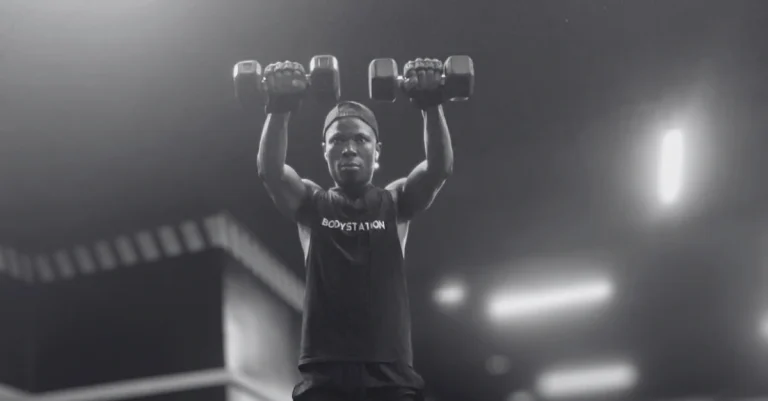 Anthony is performing dumbbell front raises as part of a full shoulder workout with dumbbells to strengthen the front deltoids