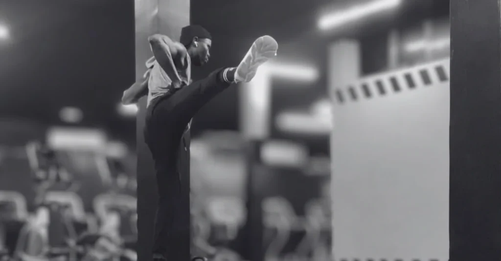 Leg swings exercise: Anthony performing side-to-side leg swings to improve hip mobility and activate the lower body