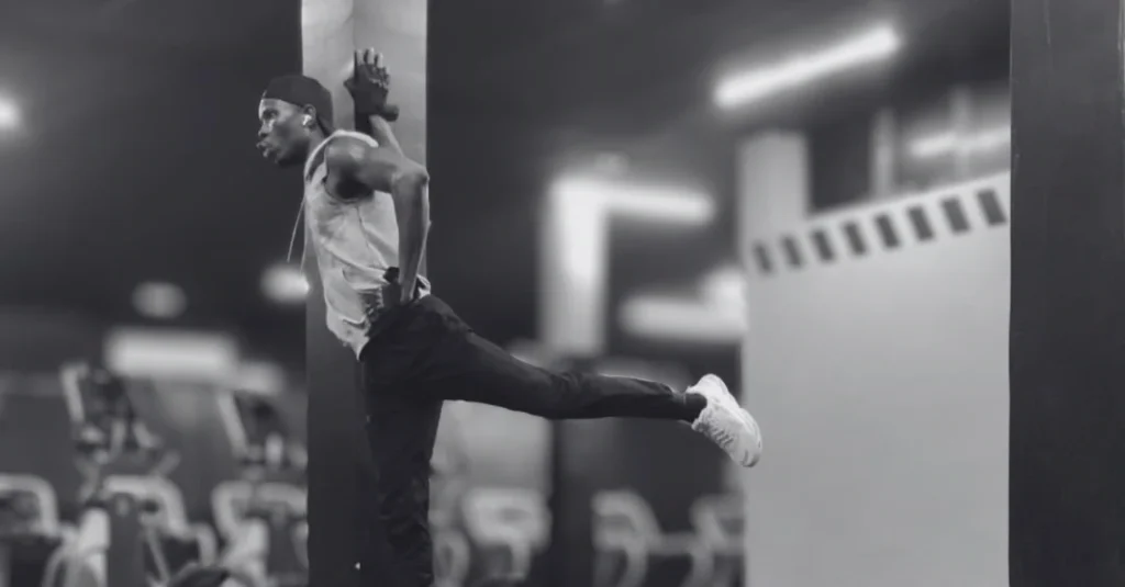 Anthony performing a backward leg swing to improve hip mobility and activate the glutes before a workout