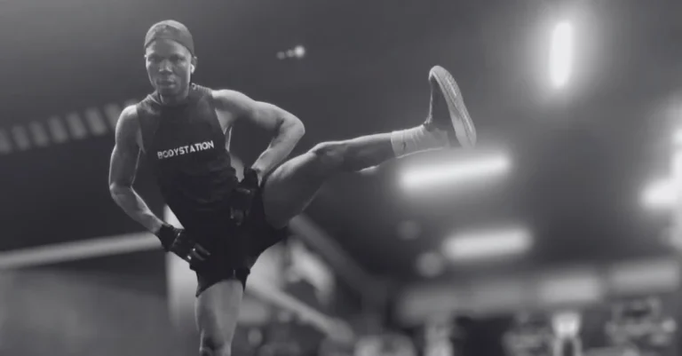 Leg swings exercise: Anthony performing side-to-side leg swings to improve hip mobility before a workout
