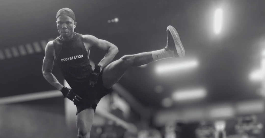 Leg swings exercise: Anthony performing side-to-side leg swings to improve hip mobility before a workout