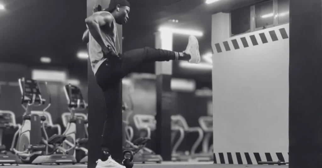 Leg swings exercise: Anthony performing front leg swings to improve hip mobility and prepare for a lower-body workout