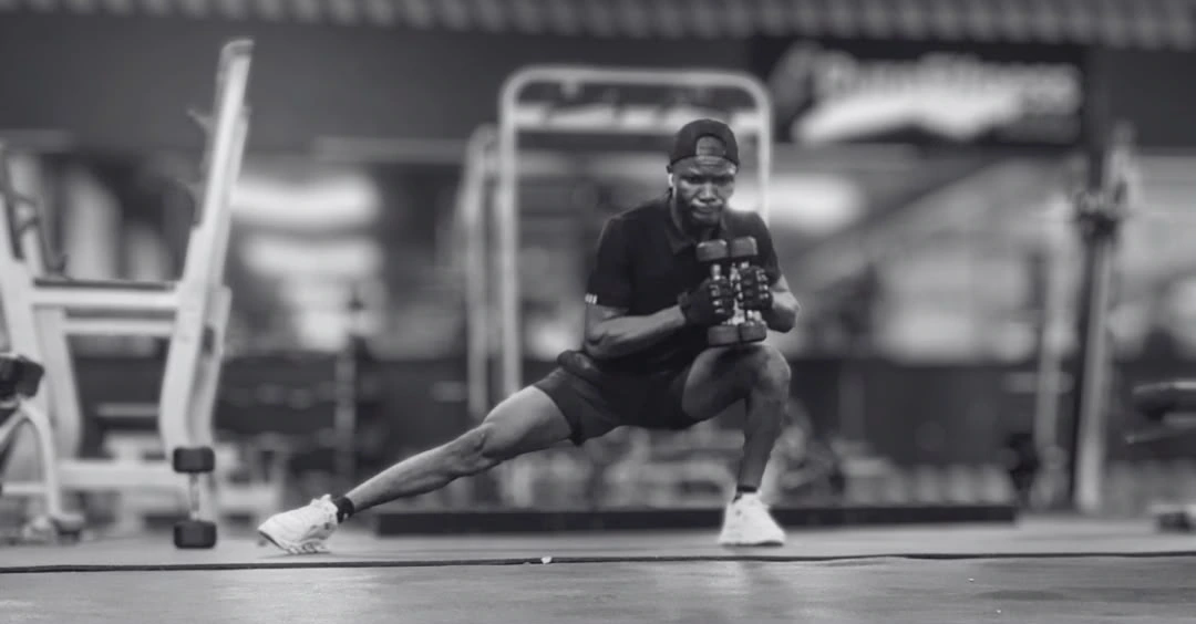 Side lunges with a dumbbell performed by Anthony during a lower-body strength workout