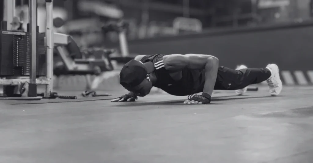 Anthony performing a standard push-up during a strength training workout for how to lose upper body fat.