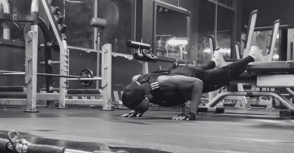 Anthony performing decline push-ups to demonstrate what muscles do push-ups work, with increased emphasis on the upper chest, shoulders, triceps, and core.