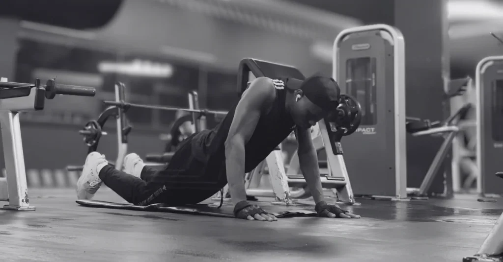 Anthony performing knee push-ups to demonstrate what muscles do push-ups work, targeting the chest, shoulders, triceps, and core with a beginner-friendly variation.