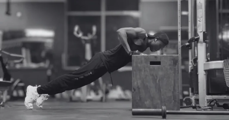 Anthony performing incline push-ups to demonstrate what muscles do push-ups work, including the chest, shoulders, triceps, and core.