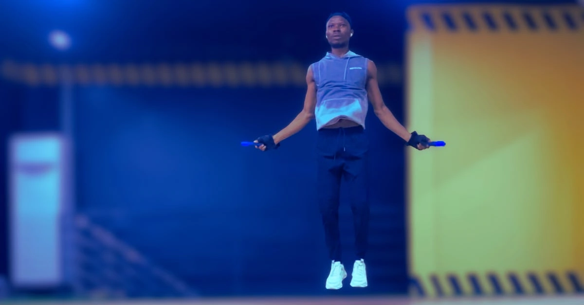 Anthony performing a jump rope exercise with proper form during a cardio workout.