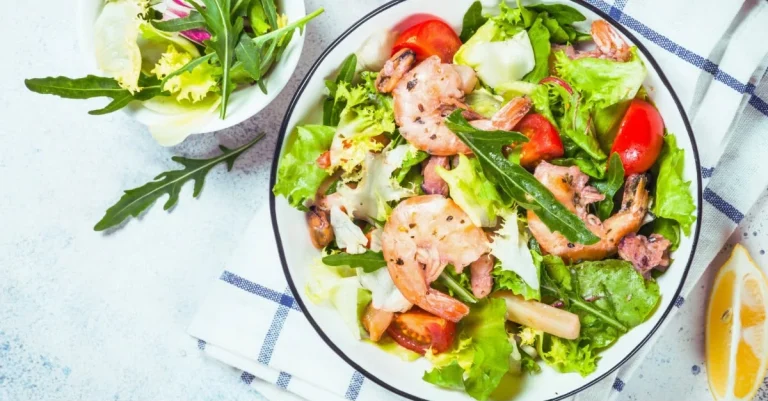 High-Protein Low-Carb Meals featuring a bowl of grilled shrimp salad with fresh vegetables and healthy ingredients