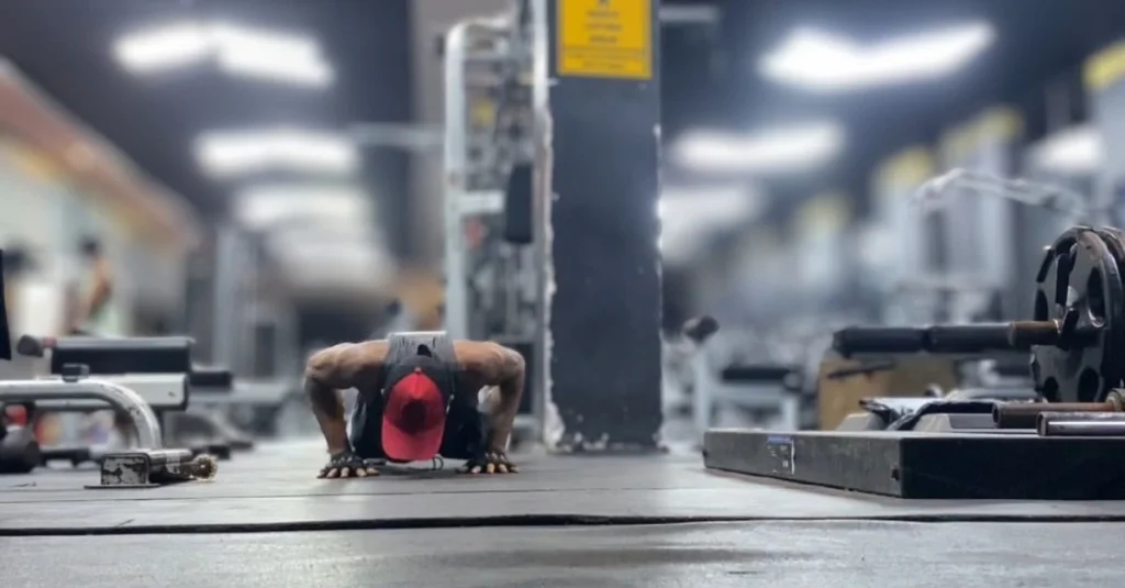 Anthony performing the push-up phase of a burpee exercise with proper form.