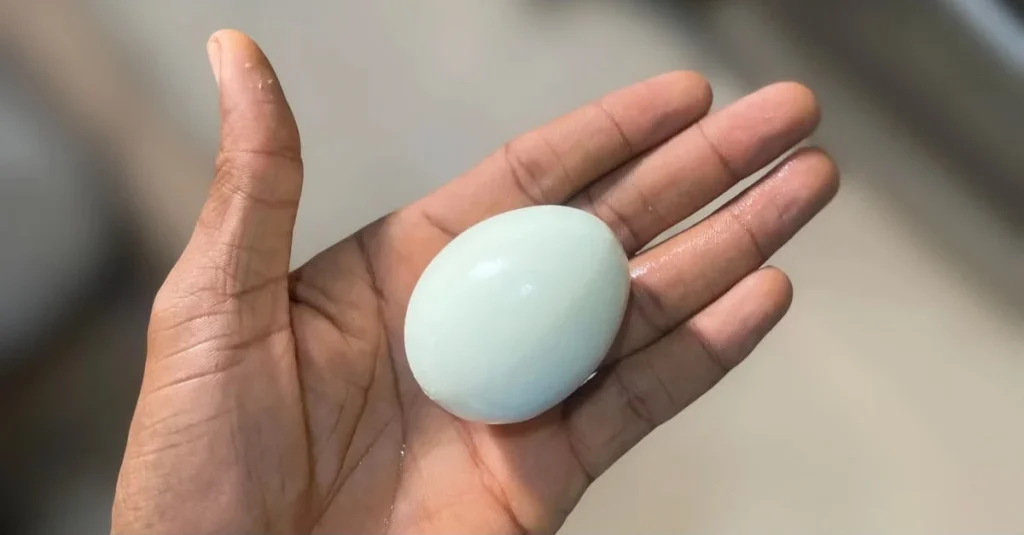 Anthony holding boiled eggs in his palm, illustrating high-protein foods for muscle building.