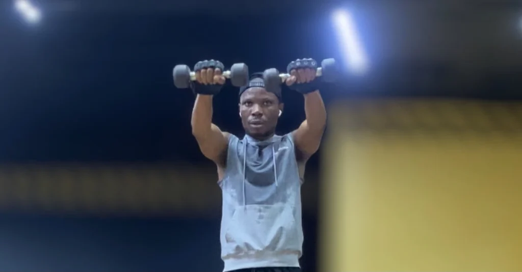 Anthony doing a dumbbell front raise to target the front shoulders