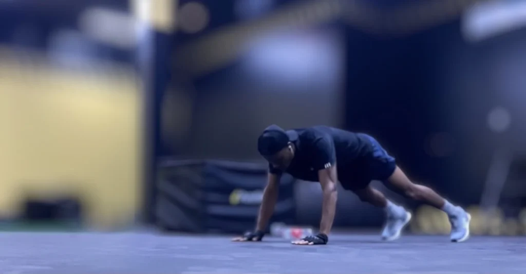 Anthony preparing to do a push-up during a workout