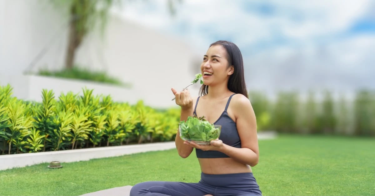 Woman enjoying a healthy, balanced meal as part of healthy eating habits after 30.