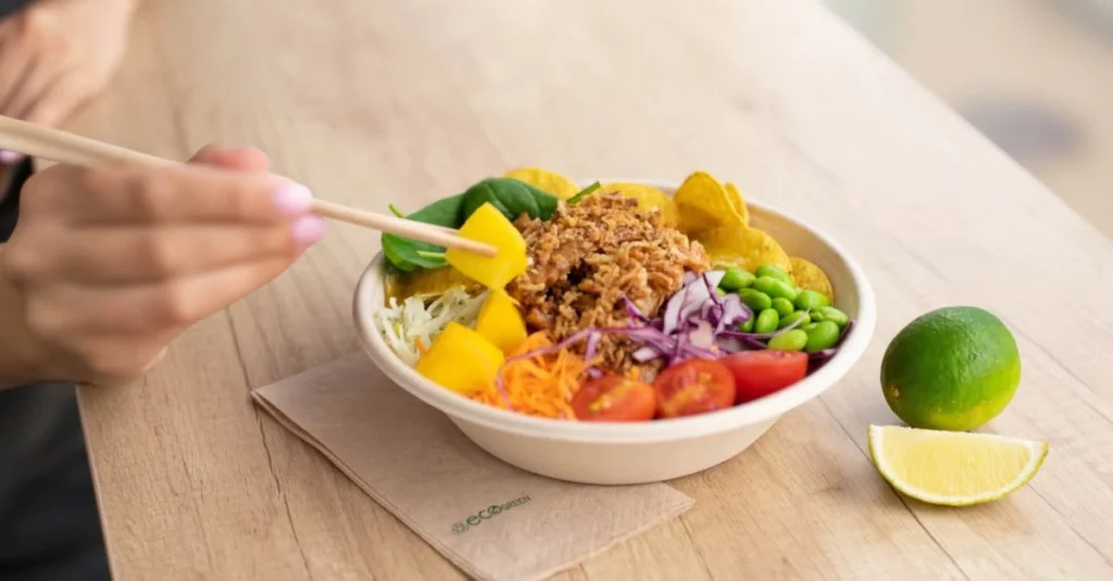 Person eating a healthy meal with fresh fruit