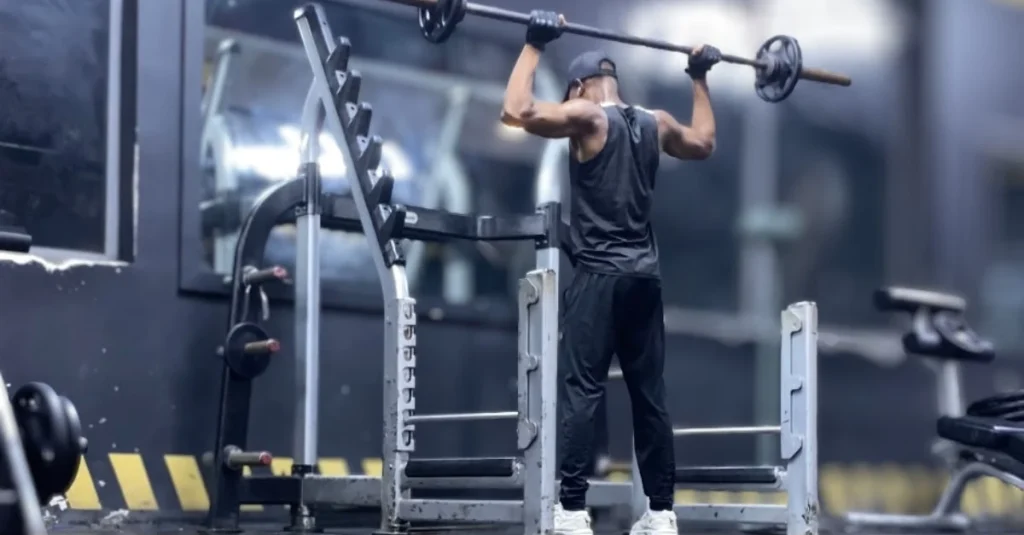 Anthony performing a barbell shoulder press during strength training