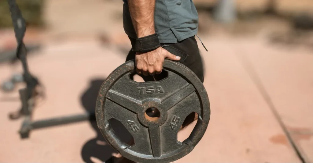 Man holding a weight plate during a workout