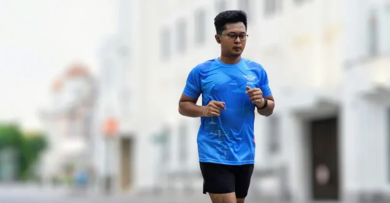 Chinese man jogging outdoors as part of staying active with fitness after 30
