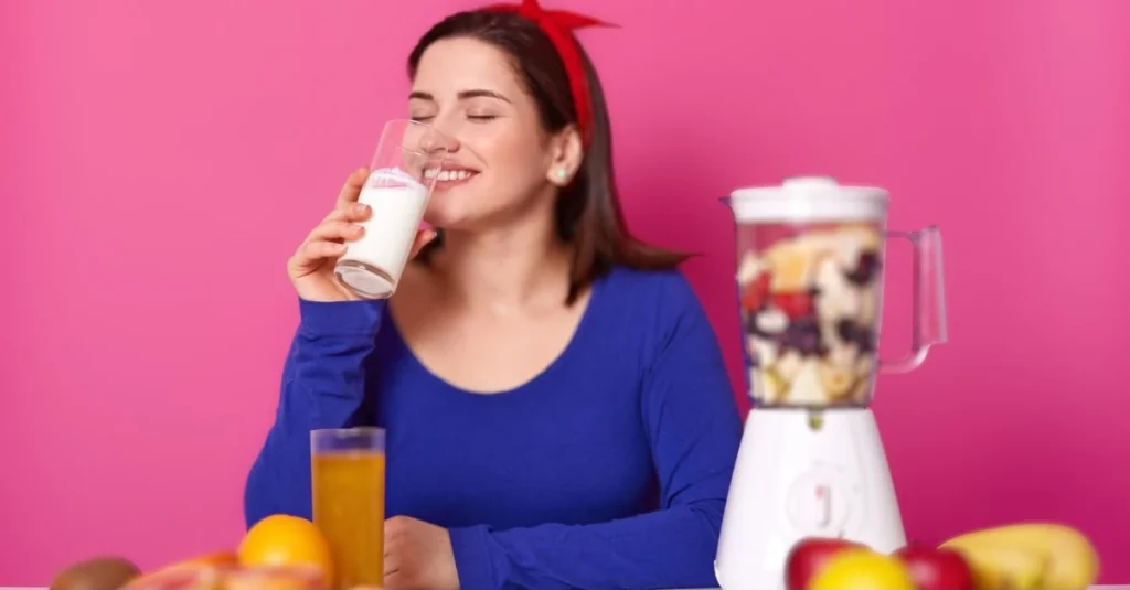 Woman drinking milk with fruit as part of a healthy fitness routine after 30