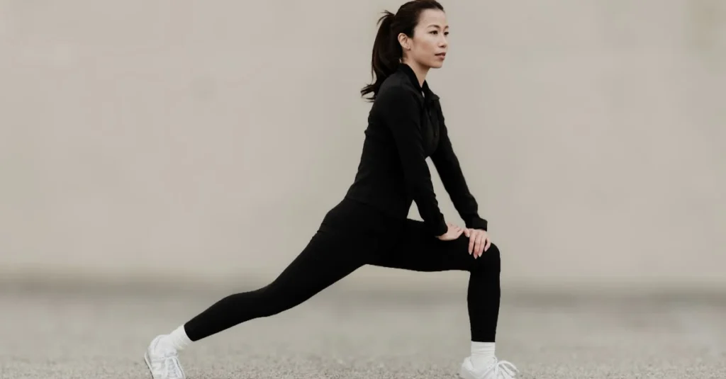 Woman performing forward lunges during a home workout.